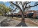 Charming street view featuring a variety of shops and restaurants in a brick building with mature trees at 101 W Oakland Ave, Oakland, FL 34760
