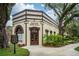 Exterior view of the historic Oakland Town Hall building with manicured landscaping at 101 W Oakland Ave, Oakland, FL 34760