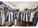 Walk-in closet with wire shelving, full of clothes, shoes and bags at 101 W Oakland Ave, Oakland, FL 34760