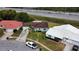 An aerial view reveals a home with meticulous landscaping near a tranquil highway and waterway at 10125 Matchlock Dr, Orlando, FL 32821