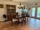 Elegant dining room with a chandelier, china cabinet, and large table at 10125 Matchlock Dr, Orlando, FL 32821