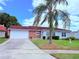 Charming single-story home with a well-manicured lawn, inviting curb appeal, and a red tiled roof at 10125 Matchlock Dr, Orlando, FL 32821