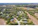 Panoramic aerial view captures a tranquil community surrounded by green spaces, lakes, and homes nestled among mature trees at 1024 Destin Dr, Lake Wales, FL 33898