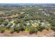 Breathtaking aerial view captures a tranquil community surrounded by lush trees, green lawns, and serene lakes in the distance at 1024 Destin Dr, Lake Wales, FL 33898