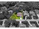 Aerial view of the home surrounded by lush greenery, highlighting its private screened pool and well-maintained yard at 1024 Destin Dr, Lake Wales, FL 33898