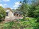 Charming home with a private screened pool, brick patio, and spacious green backyard at 1024 Destin Dr, Lake Wales, FL 33898