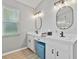 Bathroom with dual sinks, white cabinetry, and modern fixtures at 1024 Destin Dr, Lake Wales, FL 33898