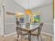 Inviting dining area with stylish light fixture and views of screened outdoor lanai at 1024 Destin Dr, Lake Wales, FL 33898