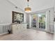 Dining room featuring light gray walls, wood-look flooring, and bright, large windows at 1024 Destin Dr, Lake Wales, FL 33898