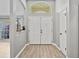 The entryway features wood-look flooring and double doors at 1024 Destin Dr, Lake Wales, FL 33898