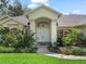 Close up of the home's main entry, showcasing the double door entry and manicured landscaping at 1024 Destin Dr, Lake Wales, FL 33898