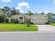 Lovely single-story home with a neatly manicured lawn, mature palm trees, and an attached two-car garage at 1024 Destin Dr, Lake Wales, FL 33898