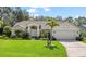 Charming one-story home featuring a well-manicured lawn and a two-car garage at 1024 Destin Dr, Lake Wales, FL 33898