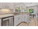 Bright kitchen boasts stainless steel appliances, granite countertops, and a breakfast nook at 1024 Destin Dr, Lake Wales, FL 33898