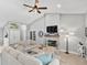 Bright living room featuring a stone fireplace and vaulted ceilings at 1024 Destin Dr, Lake Wales, FL 33898