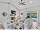 Bright living room with a fireplace, cozy furniture and sliding glass doors to a screened lanai at 1024 Destin Dr, Lake Wales, FL 33898