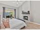 Main bedroom featuring vaulted ceilings, stylish fireplace, and slider leading to the lanai at 1024 Destin Dr, Lake Wales, FL 33898