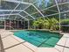 Private screened pool surrounded by lush landscaping provides a serene retreat at 1024 Destin Dr, Lake Wales, FL 33898
