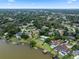 Expansive aerial view showcasing luxurious waterfront homes, lush landscaping, and private docks on a serene lake at 103 Greenleaf Ln, Altamonte Springs, FL 32714