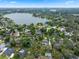 Breathtaking aerial view of a community surrounding a pristine lake, lush greenery, and beautiful blue skies at 103 Greenleaf Ln, Altamonte Springs, FL 32714