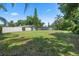 Large backyard with well-manicured lawn, white privacy fence, and mature trees at 103 Greenleaf Ln, Altamonte Springs, FL 32714