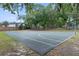 A community basketball court surrounded by mature trees, perfect for recreational games and neighborhood gatherings at 103 Greenleaf Ln, Altamonte Springs, FL 32714