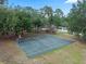 Full basketball court featuring playground equipment surrounded by large mature trees in a green recreational area at 103 Greenleaf Ln, Altamonte Springs, FL 32714