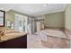 Bathroom featuring a walk-in shower, large soaking tub with stone surround, and a granite vanity sink at 103 Greenleaf Ln, Altamonte Springs, FL 32714