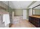 Bathroom featuring a walk-in shower, large soaking tub with stone surround, and a granite vanity sink at 103 Greenleaf Ln, Altamonte Springs, FL 32714