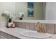 Close up on a bathroom with a brass faucet and tiled countertop at 103 Greenleaf Ln, Altamonte Springs, FL 32714