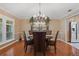 Elegant dining room featuring hardwood floors, a chandelier, and ample light with modern stainless fridge at 103 Greenleaf Ln, Altamonte Springs, FL 32714