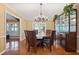 Elegant dining room features a chandelier, hardwood floors, and built-in display cabinet at 103 Greenleaf Ln, Altamonte Springs, FL 32714