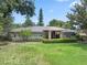 Charming single-story home with stone accents, arched windows, manicured landscaping, and lush green lawn at 103 Greenleaf Ln, Altamonte Springs, FL 32714