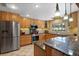 Modern kitchen features stainless steel appliances, granite countertops, and light wood cabinets at 103 Greenleaf Ln, Altamonte Springs, FL 32714
