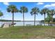 Scenic lake view with palm trees, benches, and dock, offering a tranquil waterfront experience at 103 Greenleaf Ln, Altamonte Springs, FL 32714