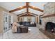 Comfortable living room with exposed wooden beams, a fireplace, and a large leather sofa at 103 Greenleaf Ln, Altamonte Springs, FL 32714