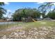 A charming park playground featuring swings, a slide, and a unique jungle gym for endless fun and recreation at 103 Greenleaf Ln, Altamonte Springs, FL 32714