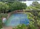 Aerial view of two full-size tennis courts surrounded by mature trees in a lakeside neighborhood at 103 Greenleaf Ln, Altamonte Springs, FL 32714