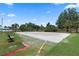 Outdoor sand volleyball court surrounded by lush greenery and palm trees, perfect for community fun and exercise at 103 Greenleaf Ln, Altamonte Springs, FL 32714