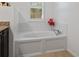 White bathroom featuring a modern soaking tub and bright natural lighting at 1062 Winglewood, Altamonte Springs, FL 32714