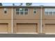 Townhouse exterior featuring multiple garage doors and a neutral color scheme at 1062 Winglewood, Altamonte Springs, FL 32714