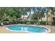 Community pool featuring clear water and seating, surrounded by lush landscaping and palm trees at 1062 Winglewood, Altamonte Springs, FL 32714