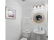 Clean, modern powder room with pedestal sink and elegant mirror at 1062 Winglewood, Altamonte Springs, FL 32714