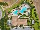 Overhead view showcasing the luxurious pool and amenity center surrounded by lush landscaping at 1082 Trappers Trail Loop, Davenport, FL 33896