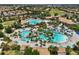 Extensive aerial view of the community pools and amenities, surrounded by lush landscaping and homes at 1082 Trappers Trail Loop, Davenport, FL 33896