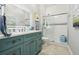 Stylish bathroom with a sleek vanity, backlit mirror, and glass-enclosed shower at 1082 Trappers Trail Loop, Davenport, FL 33896