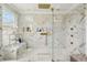 Modern bathroom features a glass shower, gold fixtures, marble tiling, and a built-in bench at 1082 Trappers Trail Loop, Davenport, FL 33896