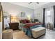 Serene bedroom with soft lighting and a cushioned bench at 1082 Trappers Trail Loop, Davenport, FL 33896