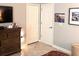 Neutral bedroom featuring a chest of drawers, closet, and modern decor at 1082 Trappers Trail Loop, Davenport, FL 33896