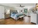 Relaxing bedroom with hardwood floors, a floral bedspread and natural light at 1082 Trappers Trail Loop, Davenport, FL 33896